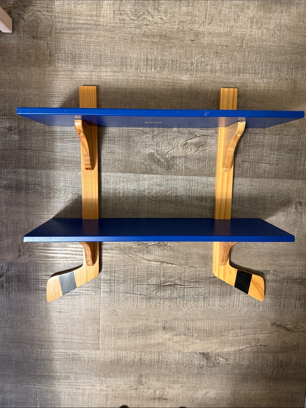 Hockey display shelf .  Blue Wall Shelf with Natural Wood Brackets